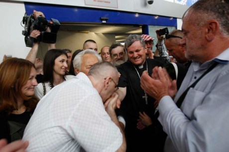 Dario Kordic kisses Bishop Vlado Kosic's hand Zagreb Airport 6 June 2014 (Photo: Ranko Suvar/CROPIX)