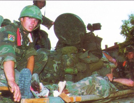Croat wounded soldier attended to by mates