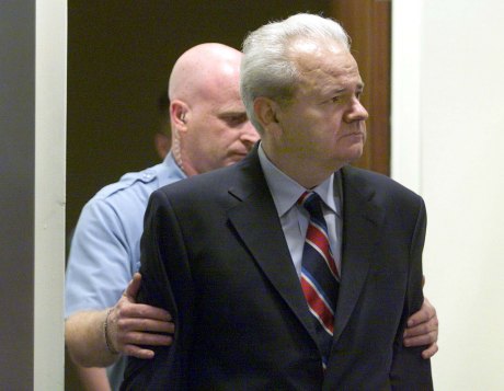 Former Serbian president Slobodan Milosevic is led into the courtroom of the UN War Crimes Tribunal in The Hague 2002 PHOTO : JERRY LAMPEN/AFP/Getty Images 